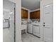 Laundry room featuring modern washer and dryer set, storage cabinets and utility sink at 16070 Palawan Ct, Tega Cay, SC 29708