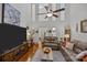 Cozy living room with a high ceiling, fan, wood floors, and multiple seating options at 16070 Palawan Ct, Tega Cay, SC 29708