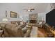 Comfortable living room with a stone fireplace, wood floors, and neutral colored furniture at 16070 Palawan Ct, Tega Cay, SC 29708