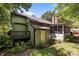 View of the rear exterior, featuring a deck and screened porch, surrounded by lush trees at 16070 Palawan Ct, Tega Cay, SC 29708