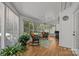 Bright sunroom with lots of windows, ceiling fan and two wicker rocking chairs at 16070 Palawan Ct, Tega Cay, SC 29708