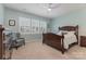 Cozy bedroom with a ceiling fan, three windows with blinds, and light blue paint at 1670 Tranquility Blvd, Lancaster, SC 29720
