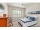 Bright bedroom featuring a ceiling fan, neutral walls, and a large window with white shutters at 1670 Tranquility Blvd, Lancaster, SC 29720