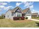 Two-story home featuring gray shingle siding, a manicured lawn, and a two-car garage at 1670 Tranquility Blvd, Lancaster, SC 29720