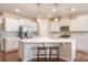 Bright kitchen with white cabinets, stainless steel appliances, and a breakfast bar with stool seating at 1670 Tranquility Blvd, Lancaster, SC 29720