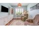 Comfortable living room with hardwood floors, light blue walls, TV, bookshelf, and a recliner at 1670 Tranquility Blvd, Lancaster, SC 29720