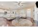 Open-concept living room with hardwood floors, comfortable seating, and seamless access to the kitchen at 1670 Tranquility Blvd, Lancaster, SC 29720
