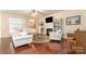 Cozy living room with a fireplace, built-in bookshelves, and hardwood floors at 1670 Tranquility Blvd, Lancaster, SC 29720
