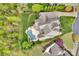 An aerial view of an estate with a pool, well manicured landscaping, an expansive yard, and circular driveway at 17909 Golden Meadow Ct, Davidson, NC 28036