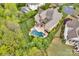 Aerial view of the beautiful backyard featuring pool, spa, lush landscaping, and expansive home at 17909 Golden Meadow Ct, Davidson, NC 28036