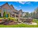 Beautiful backyard featuring a pool, stone patio, and lush landscaping at 17909 Golden Meadow Ct, Davidson, NC 28036