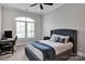 Stylish bedroom with a large window, a desk, and a comfortable bed with blue accents at 17909 Golden Meadow Ct, Davidson, NC 28036