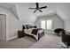 This spacious bedroom boasts neutral tones, a ceiling fan, and a light-filled window at 17909 Golden Meadow Ct, Davidson, NC 28036