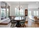 Bright dining area features hardwood floors, a built-in bench, and a wooden table under a chandelier at 17909 Golden Meadow Ct, Davidson, NC 28036