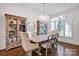 Bright dining room featuring hardwood floors, wainscoting, and decorative chandelier at 17909 Golden Meadow Ct, Davidson, NC 28036