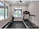 The exercise room features a treadmill, rowing machine and rubber flooring at 17909 Golden Meadow Ct, Davidson, NC 28036