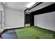 Indoor golf simulator in a spacious room at 17909 Golden Meadow Ct, Davidson, NC 28036