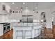 Bright kitchen boasts stainless steel appliances, large island with seating, and modern pendant lights at 17909 Golden Meadow Ct, Davidson, NC 28036