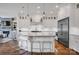 Modern kitchen with white cabinets, stainless steel appliances, pendant lighting, and hardwood floors at 17909 Golden Meadow Ct, Davidson, NC 28036