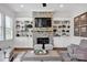 Inviting living room with stone fireplace, custom built-ins, and comfortable seating arrangement at 17909 Golden Meadow Ct, Davidson, NC 28036