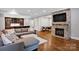 Basement living room with a stone fireplace and bar area; perfect for entertaining at 17909 Golden Meadow Ct, Davidson, NC 28036
