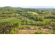 Areal view of wooded property featuring home and barns in a serene country setting surrounded by nature at 1821 Hopewell Church Rd, Hiddenite, NC 28636