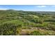 Aerial view of property showcasing home and surrounding acreage with mature trees and land at 1821 Hopewell Church Rd, Hiddenite, NC 28636