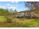 Spacious backyard featuring a well-maintained lawn and partial fencing surrounding the home at 1821 Hopewell Church Rd, Hiddenite, NC 28636