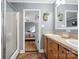 This bathroom offers dual sinks, a walk-in shower, and a view into the bedroom at 1821 Hopewell Church Rd, Hiddenite, NC 28636