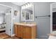 Inviting bathroom with dual sinks, wooden cabinets, and decorative wall hangings at 1821 Hopewell Church Rd, Hiddenite, NC 28636