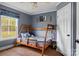Charming ' bedroom with a wooden bunk bed and a window at 1821 Hopewell Church Rd, Hiddenite, NC 28636
