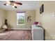 A nicely staged bedroom featuring wood floors, a window, and white furniture at 1821 Hopewell Church Rd, Hiddenite, NC 28636