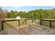 Wooden deck with railing overlooking spacious backyard with outbuilding in a beautiful location at 1821 Hopewell Church Rd, Hiddenite, NC 28636