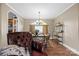 A dining room connected to the living room, with wood floors and plenty of natural light at 1821 Hopewell Church Rd, Hiddenite, NC 28636