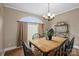 Cozy dining room boasting a large window and warm, inviting lighting at 1821 Hopewell Church Rd, Hiddenite, NC 28636