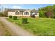 Charming single-Gathering home with classic curb appeal, neat landscaping and gravel driveway at 1821 Hopewell Church Rd, Hiddenite, NC 28636
