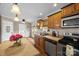 The kitchen boasts wood cabinets, a breakfast bar, and stainless steel appliances at 1821 Hopewell Church Rd, Hiddenite, NC 28636