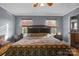 Main bedroom with hardwood floors, natural light and adjoined bathroom at 1821 Hopewell Church Rd, Hiddenite, NC 28636