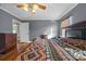 Cozy main bedroom featuring hardwood floors, grey walls, and a ceiling fan with lights at 1821 Hopewell Church Rd, Hiddenite, NC 28636