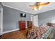 Comfortable bedroom with mounted TV, hardwood floors, and a ceiling fan at 1821 Hopewell Church Rd, Hiddenite, NC 28636