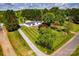 Aerial view of a charming home with lush, green landscaping and a long driveway at 186 Ellendale Ln, Taylorsville, NC 28681