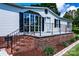 Charming exterior with brick accents and a welcoming front porch with black railings at 186 Ellendale Ln, Taylorsville, NC 28681