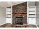 Living room featuring a stone fireplace and custom built-in shelves and cabinets at 186 Ellendale Ln, Taylorsville, NC 28681