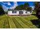 Charming single-story home with well-manicured front lawn and a covered front porch with black railings at 186 Ellendale Ln, Taylorsville, NC 28681