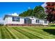 Charming single-story home featuring tidy landscaping, brick foundation and neutral siding and black shutters at 186 Ellendale Ln, Taylorsville, NC 28681
