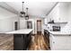 Modern kitchen featuring stainless steel appliances, white cabinets, island and trendy light fixtures at 186 Ellendale Ln, Taylorsville, NC 28681
