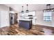 Modern kitchen with white cabinets, subway tile backsplash, and a gray center island with pendant lighting at 186 Ellendale Ln, Taylorsville, NC 28681