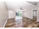 Bright living room featuring modern ceiling fan, luxury vinyl flooring and natural light at 186 Ellendale Ln, Taylorsville, NC 28681