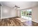 Bright living room with modern ceiling fan, luxury vinyl flooring and natural light through big picture window at 186 Ellendale Ln, Taylorsville, NC 28681