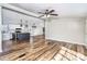 Open-concept living space with luxury vinyl flooring connecting the kitchen, dining, and living areas at 186 Ellendale Ln, Taylorsville, NC 28681
